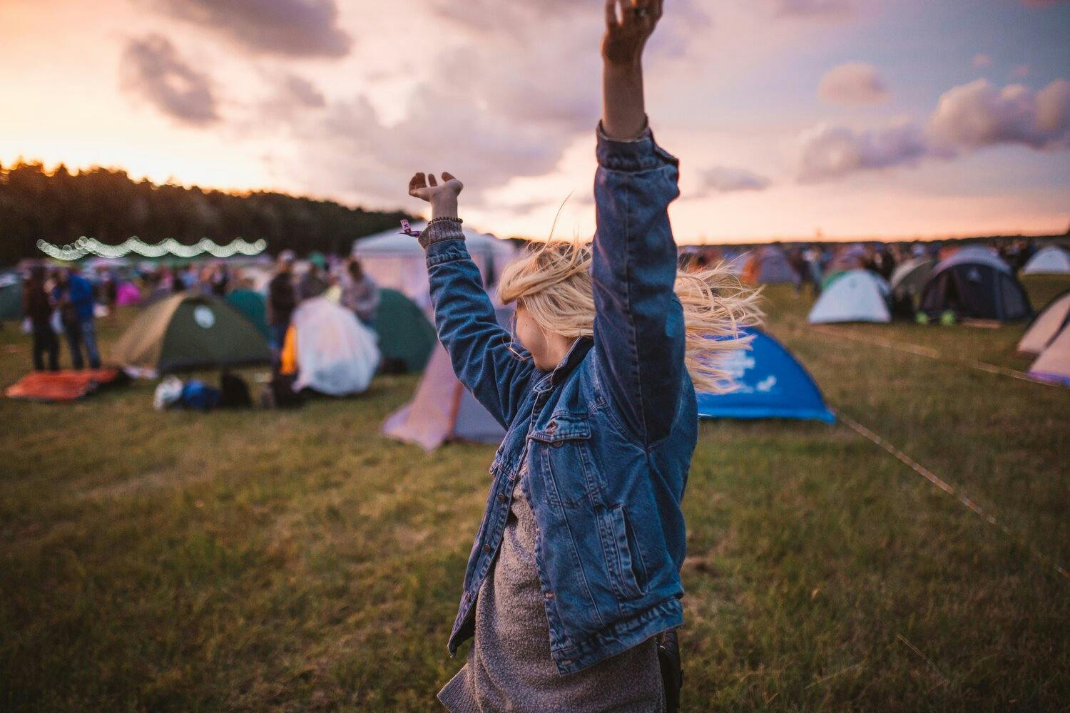 a person with her arms up in the air