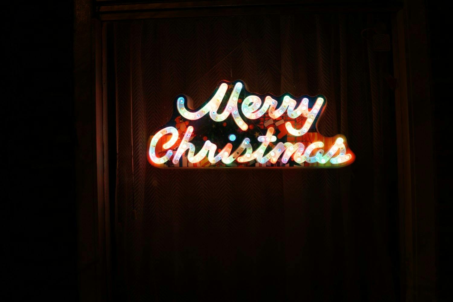 a lit up sign with a black background