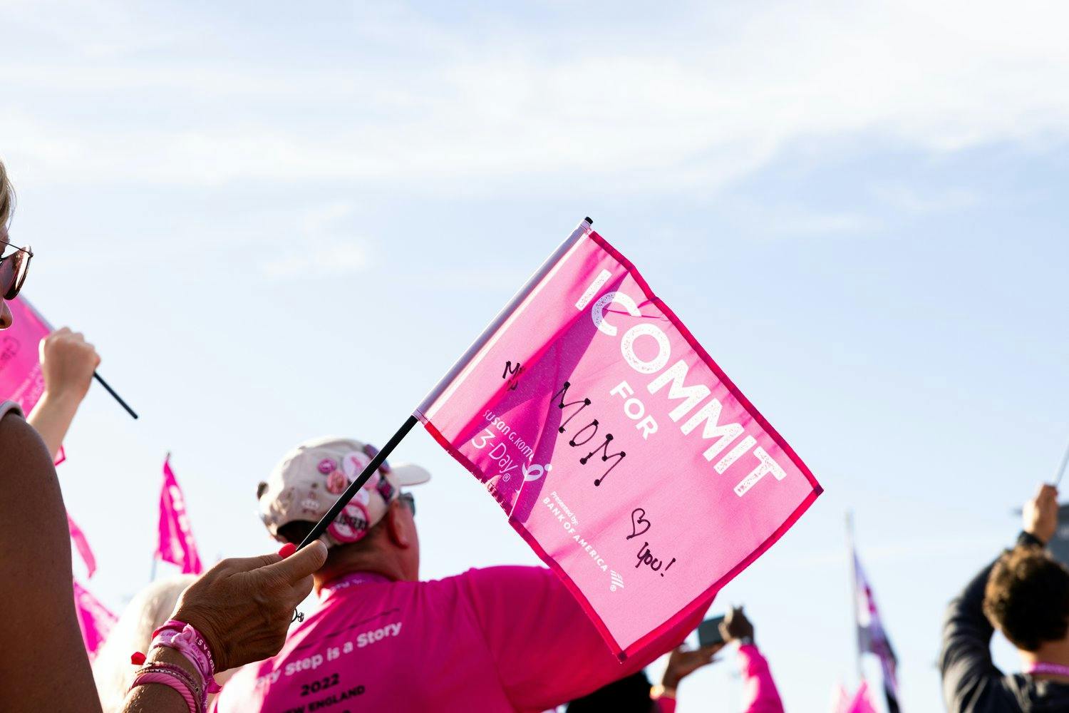 a person holding a pink flag