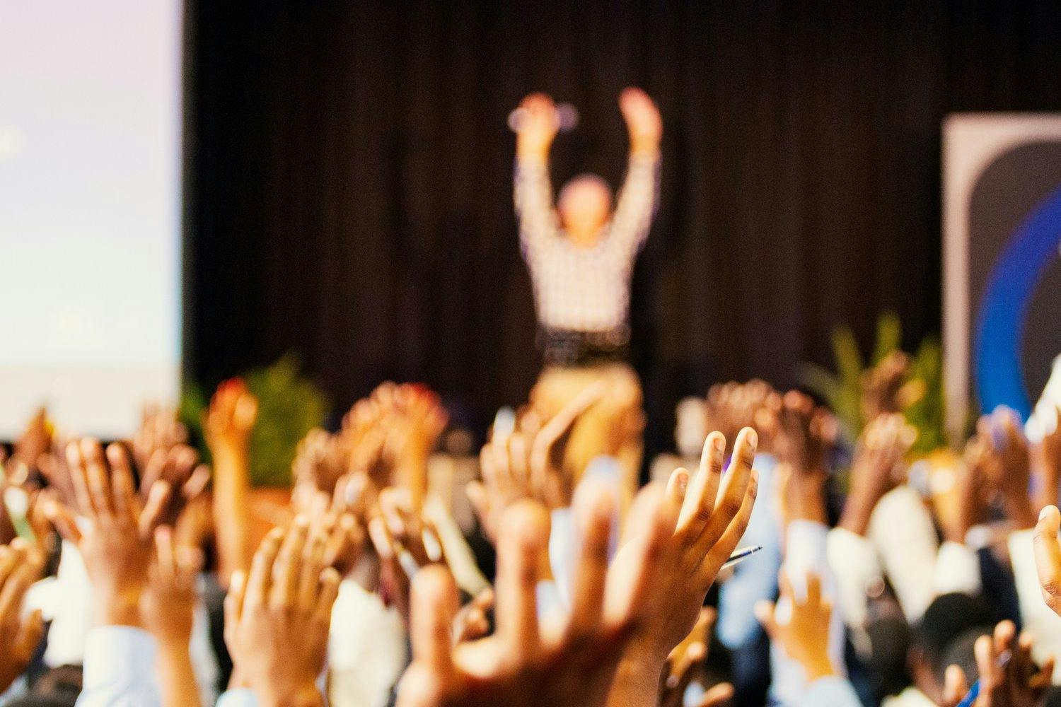 a group of people raising their hands