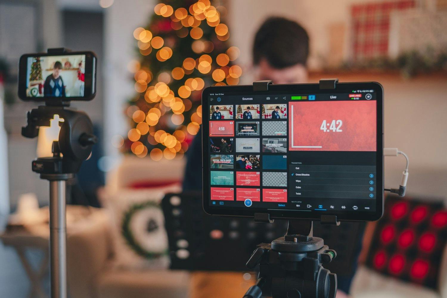 a camera and a screen with a christmas tree in the background