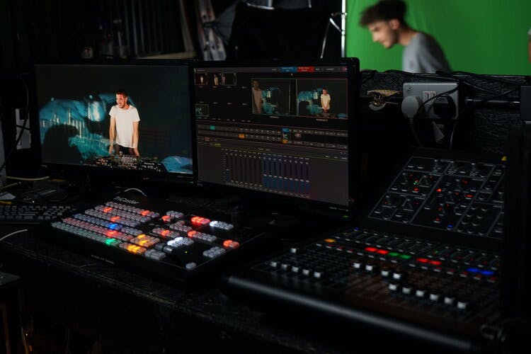 a group of monitors and a sound mixer