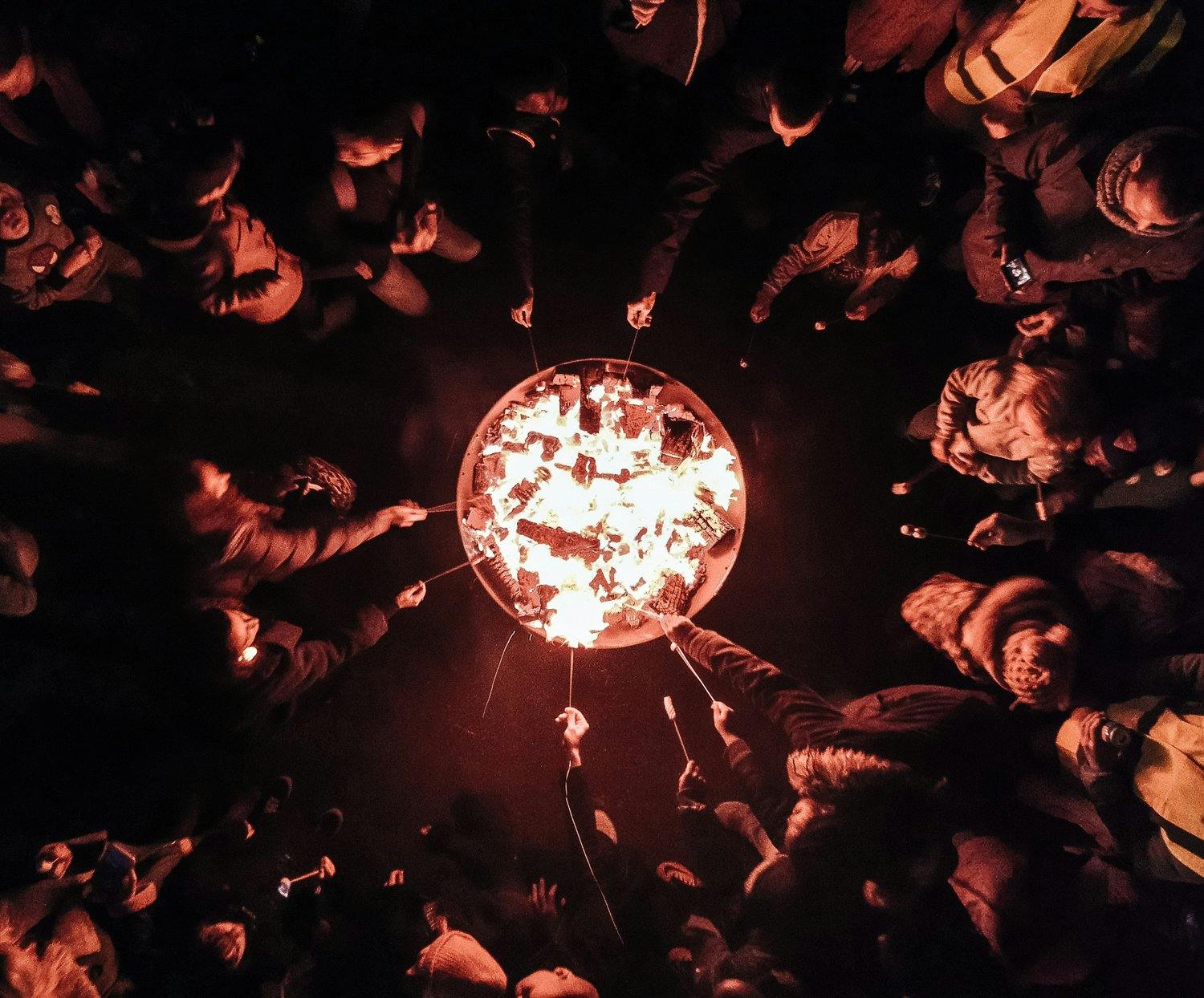 a group of people holding up a fire