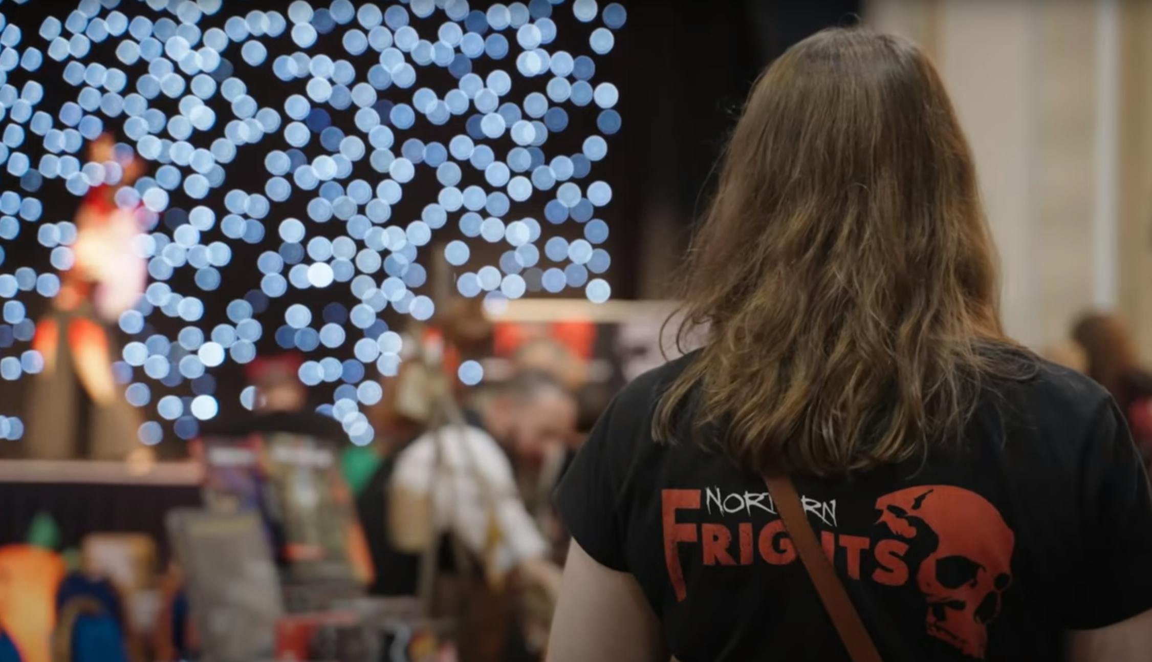 Laura event creator at Northern Frights tshirt showing logo on back