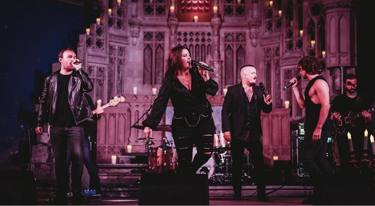 a group of people singing on a stage