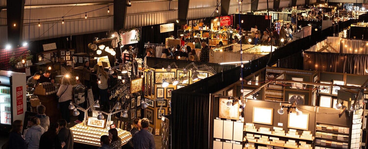 a large exhibition hall with people and craft