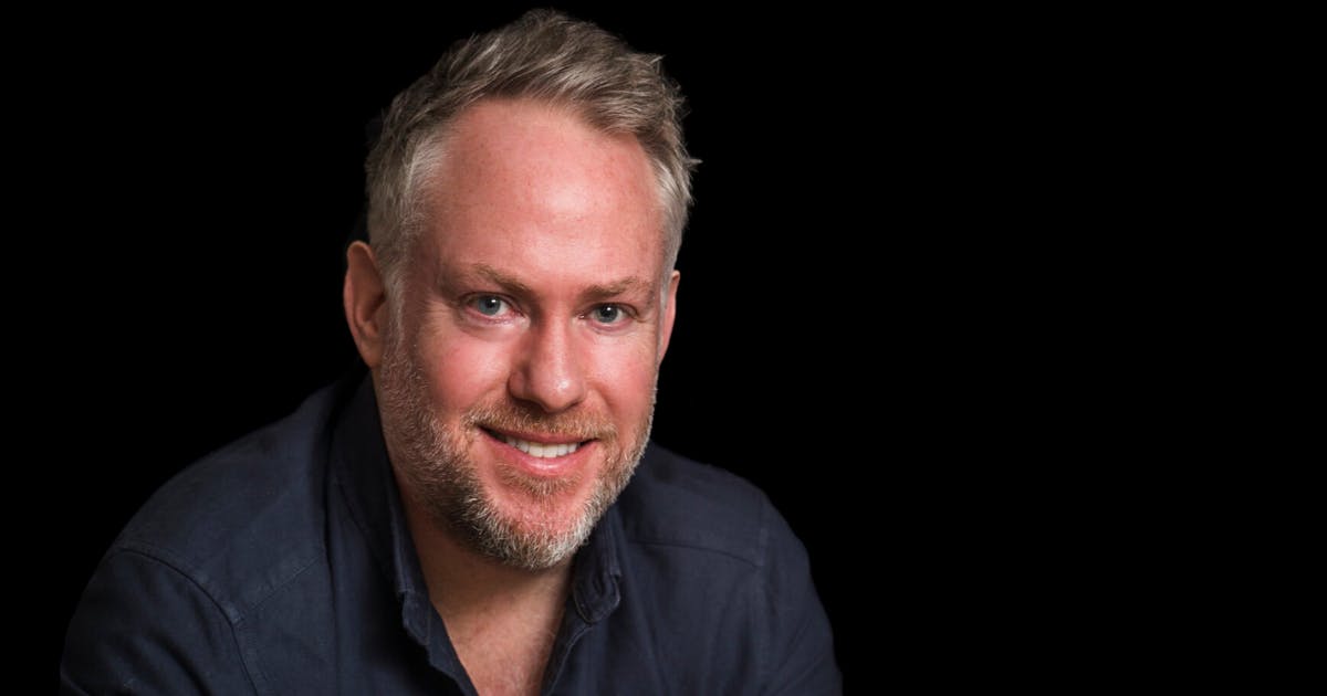 a person with a beard smiling