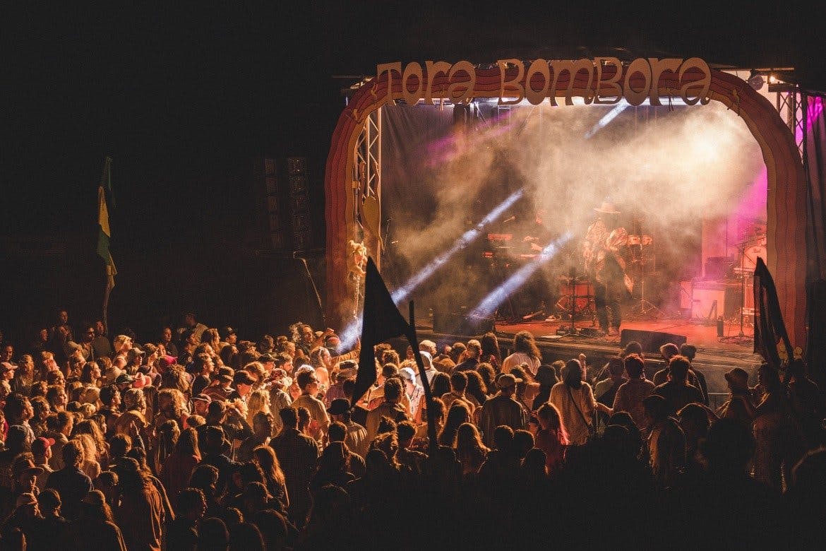 a crowd of people watching musicians on a stage