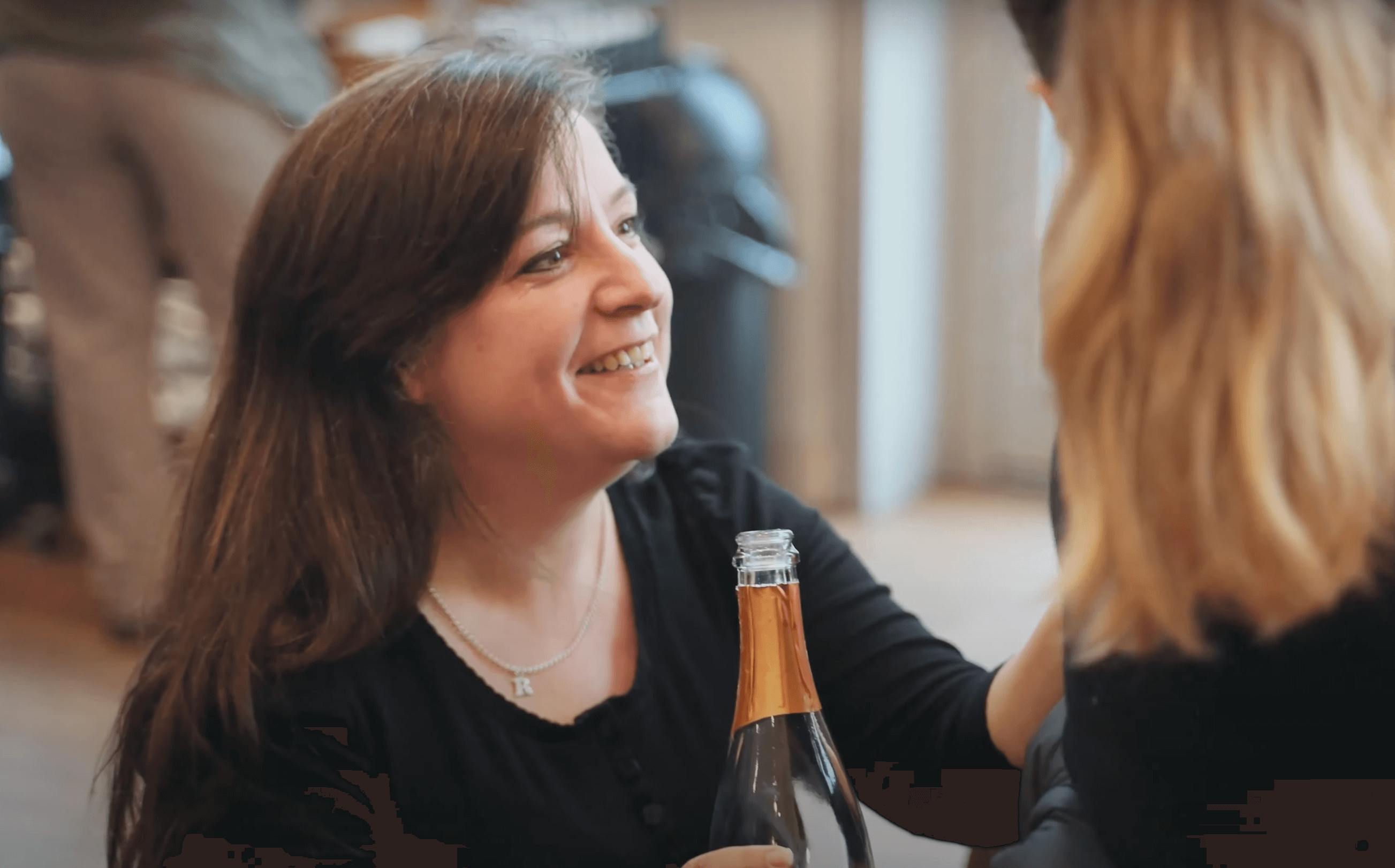 Becky Jackson serving wine at her event