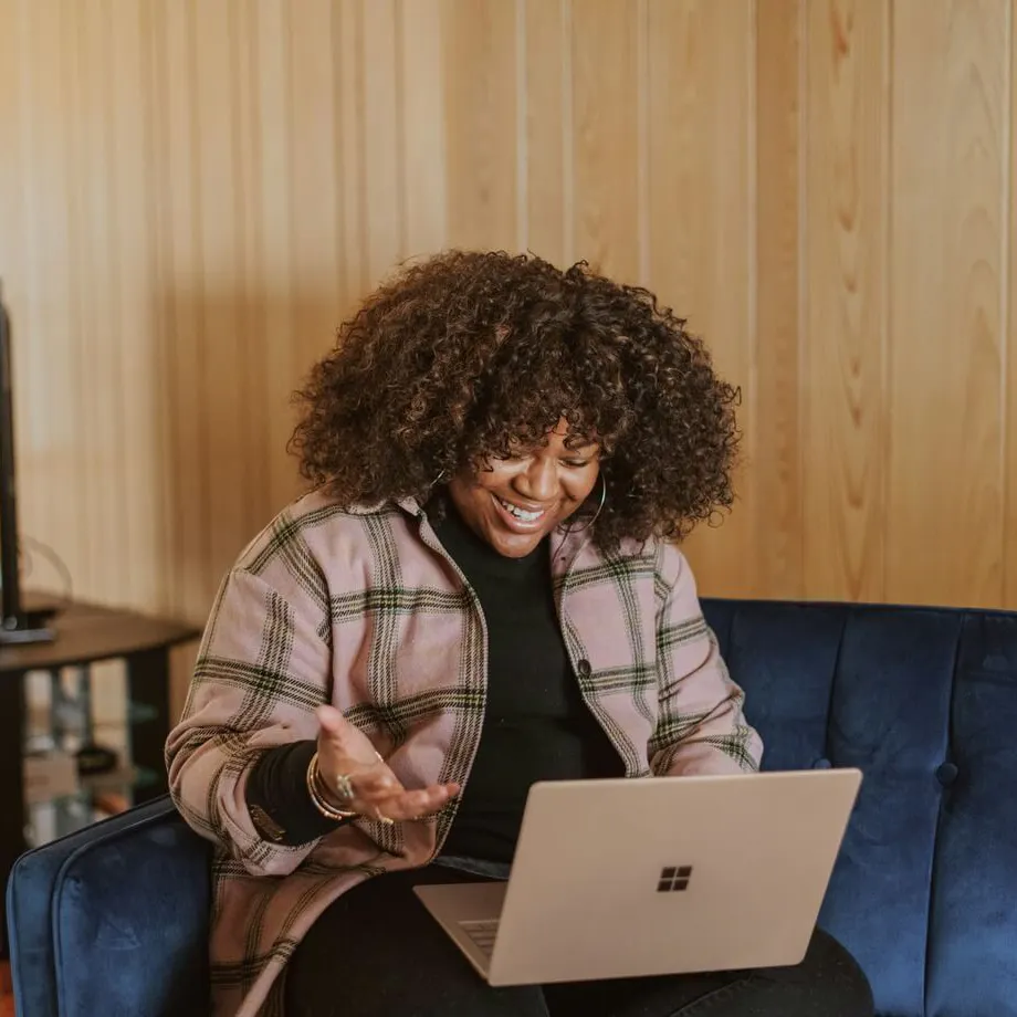 woman on her laptop smiling