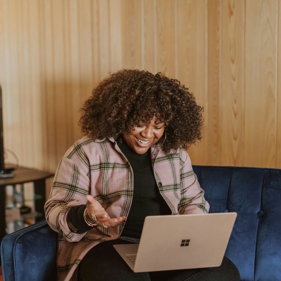 woman on her laptop smiling
