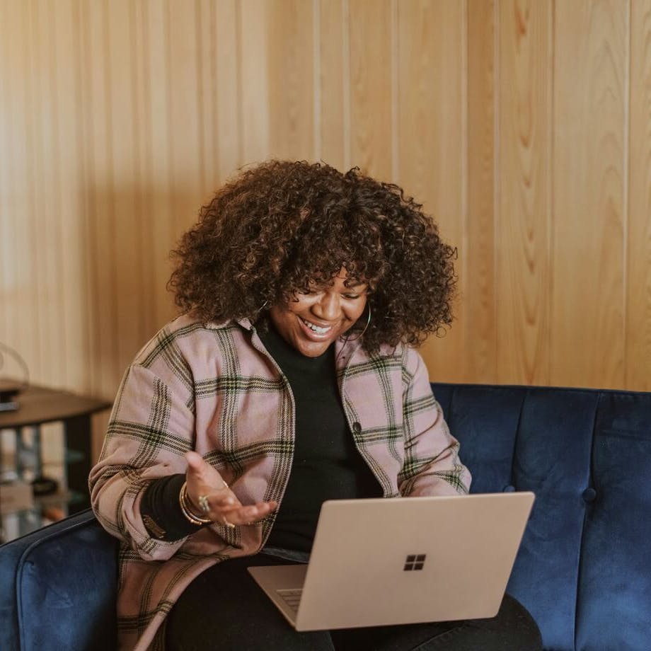 woman on her laptop smiling