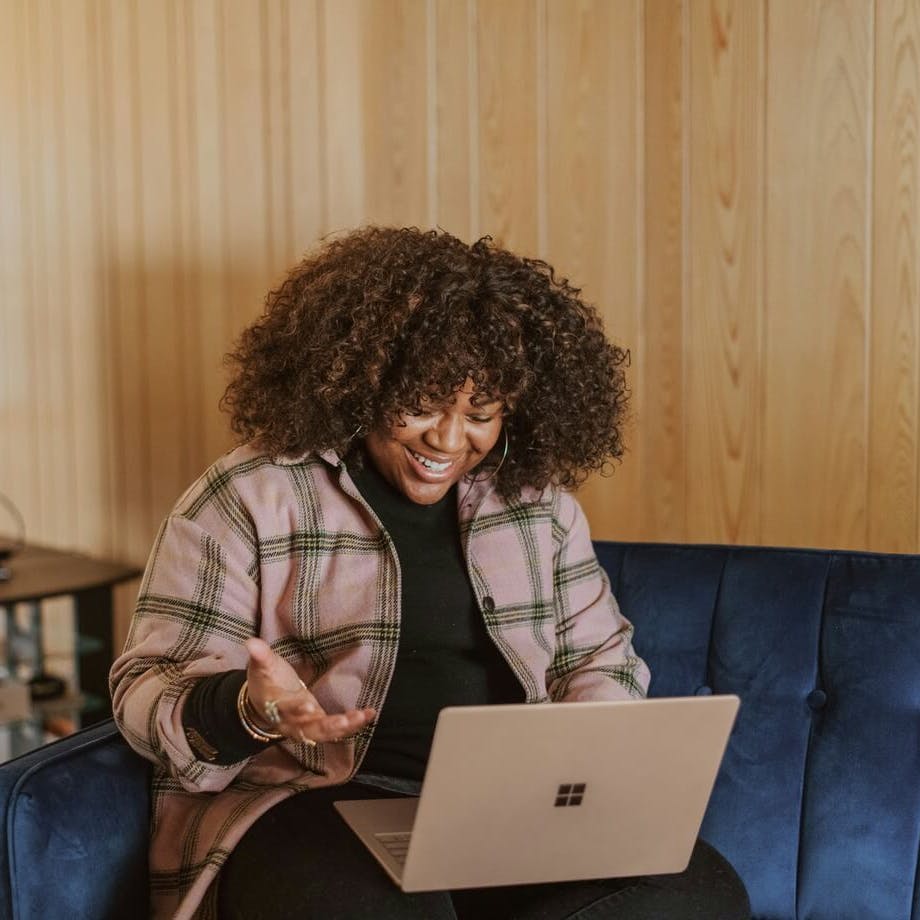 woman on her laptop smiling