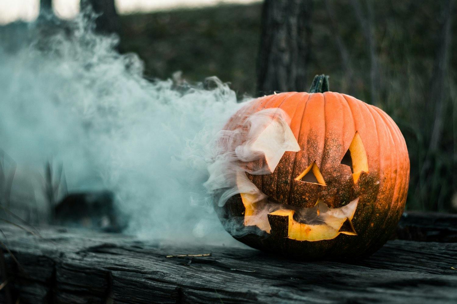 a carved pumpkin with smoke coming out of it