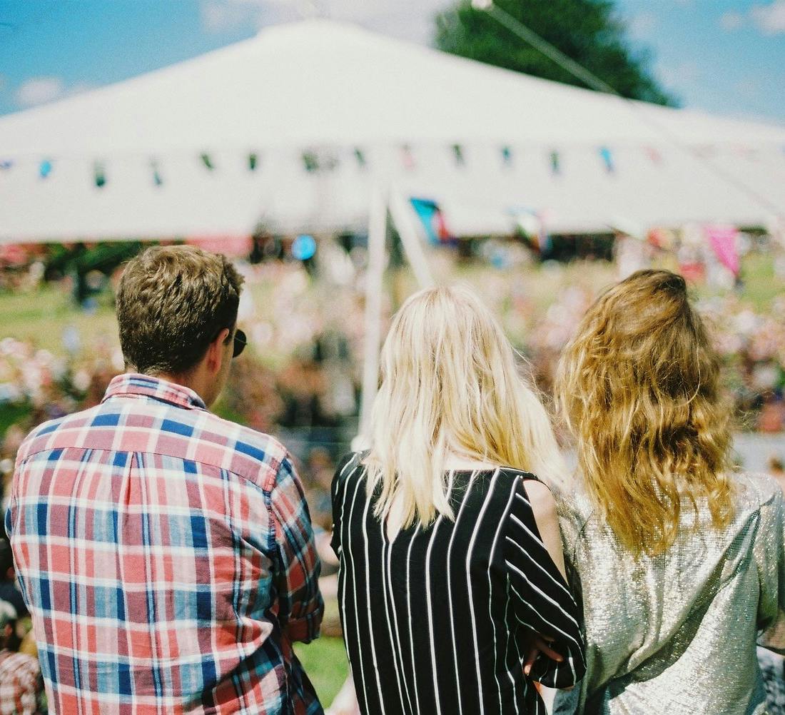 3 people on a sunny day at a festival