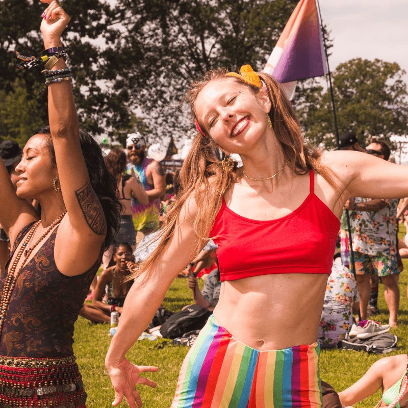 woman dancing and smiling at festival