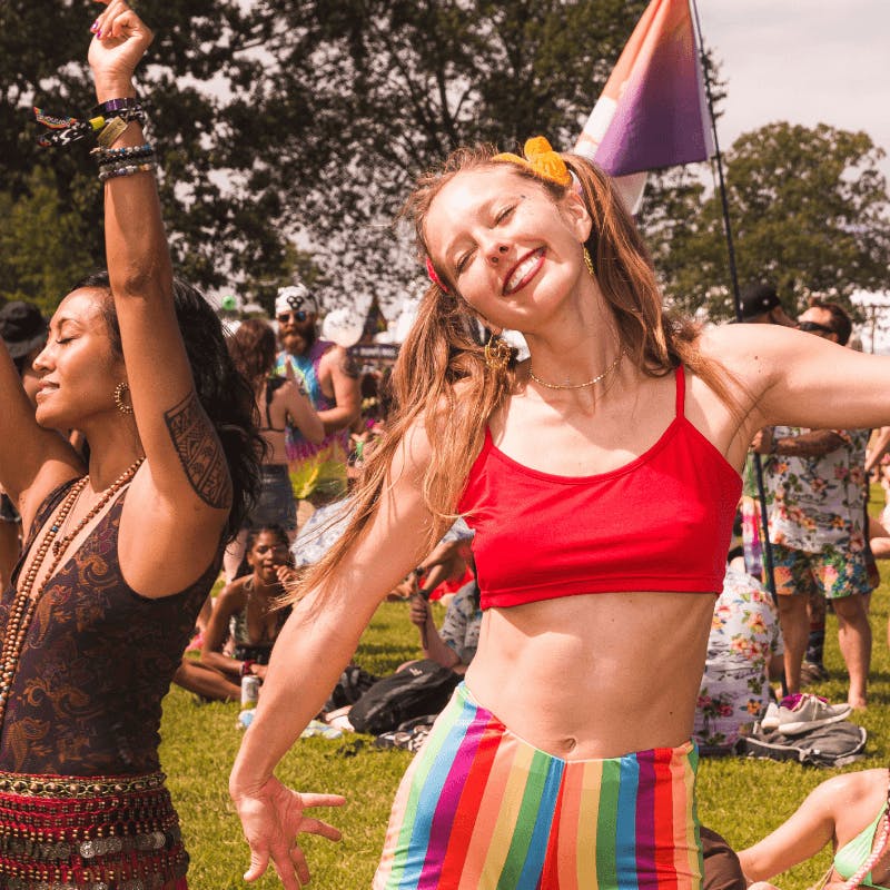 woman dancing and smiling at festival