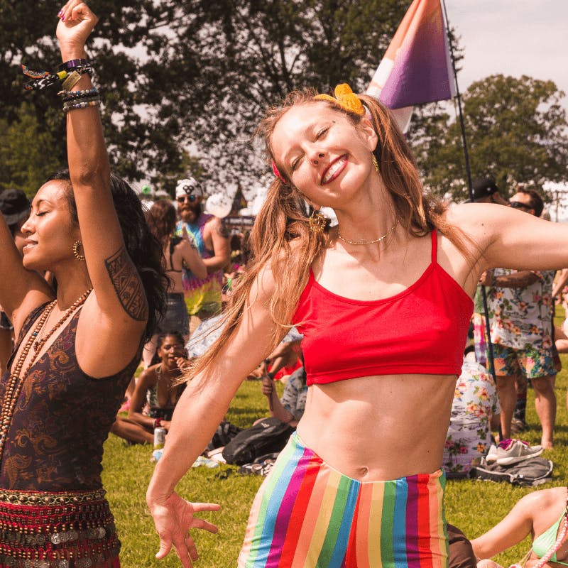 woman dancing and smiling at festival