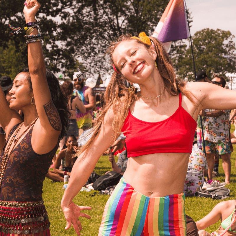 woman dancing and smiling at festival