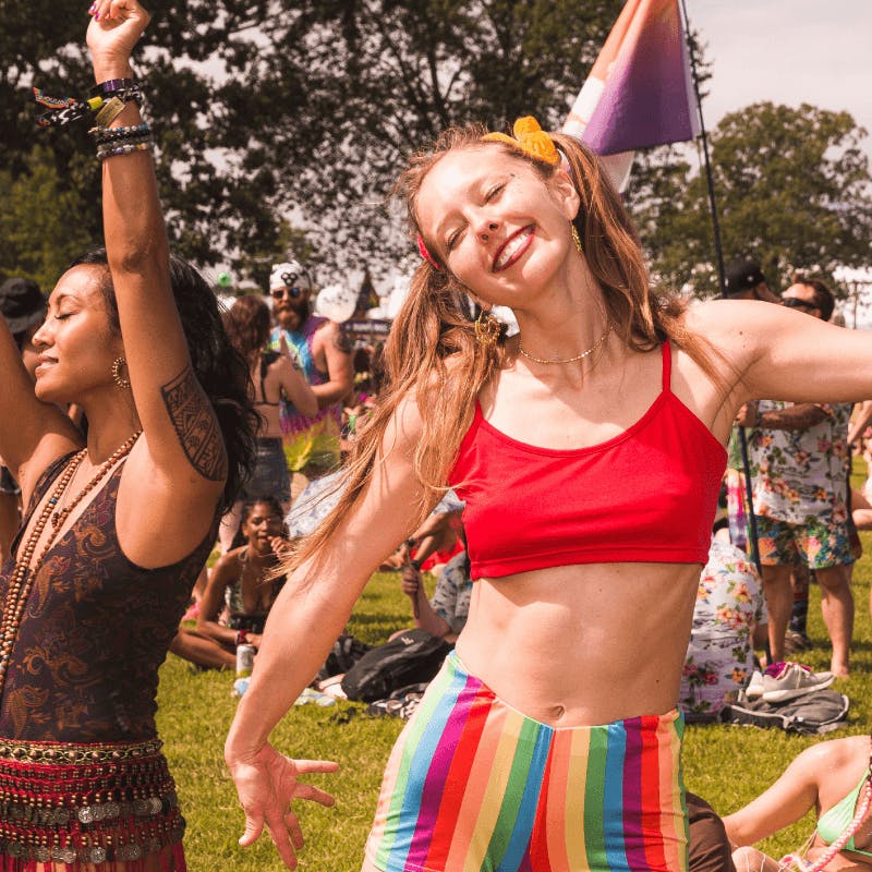 woman dancing and smiling at festival