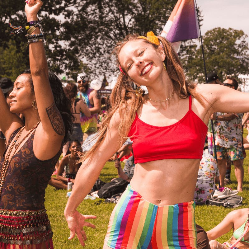 Woman dancing and smiling at music festival