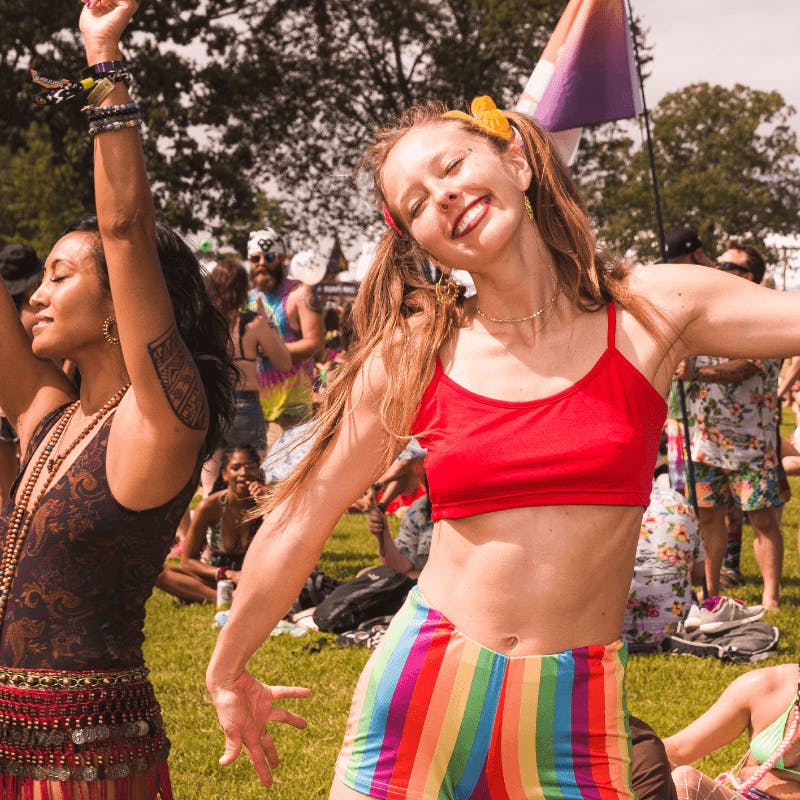 woman dancing and smiling at festival