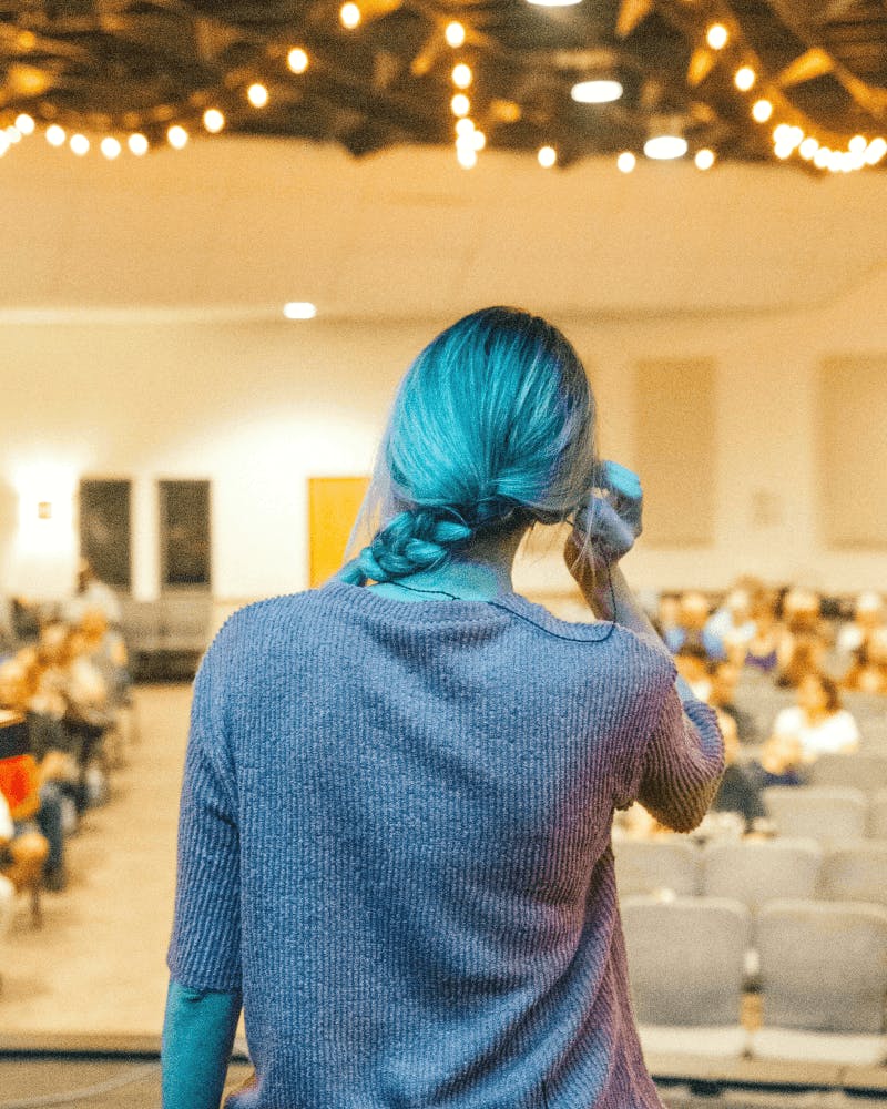 woman on stage preparing for event