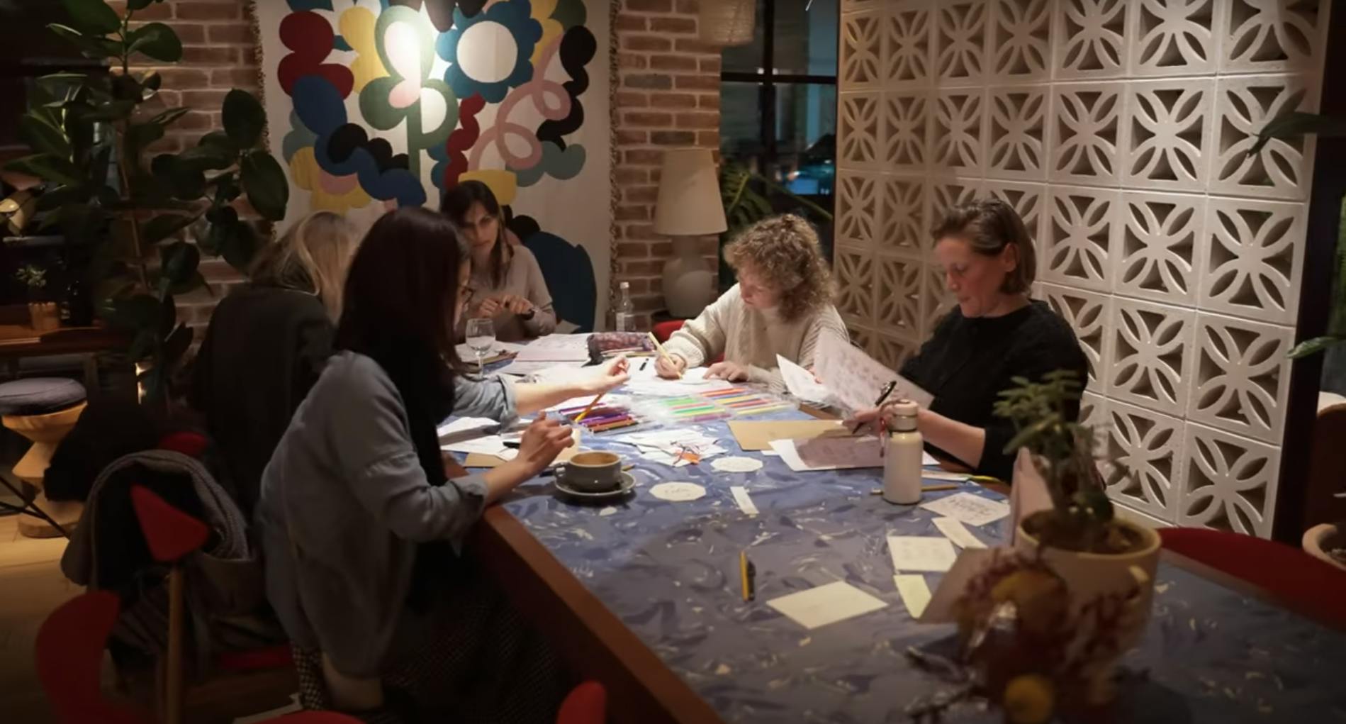 Laura Letters Life teaching a calligraphy class around a table