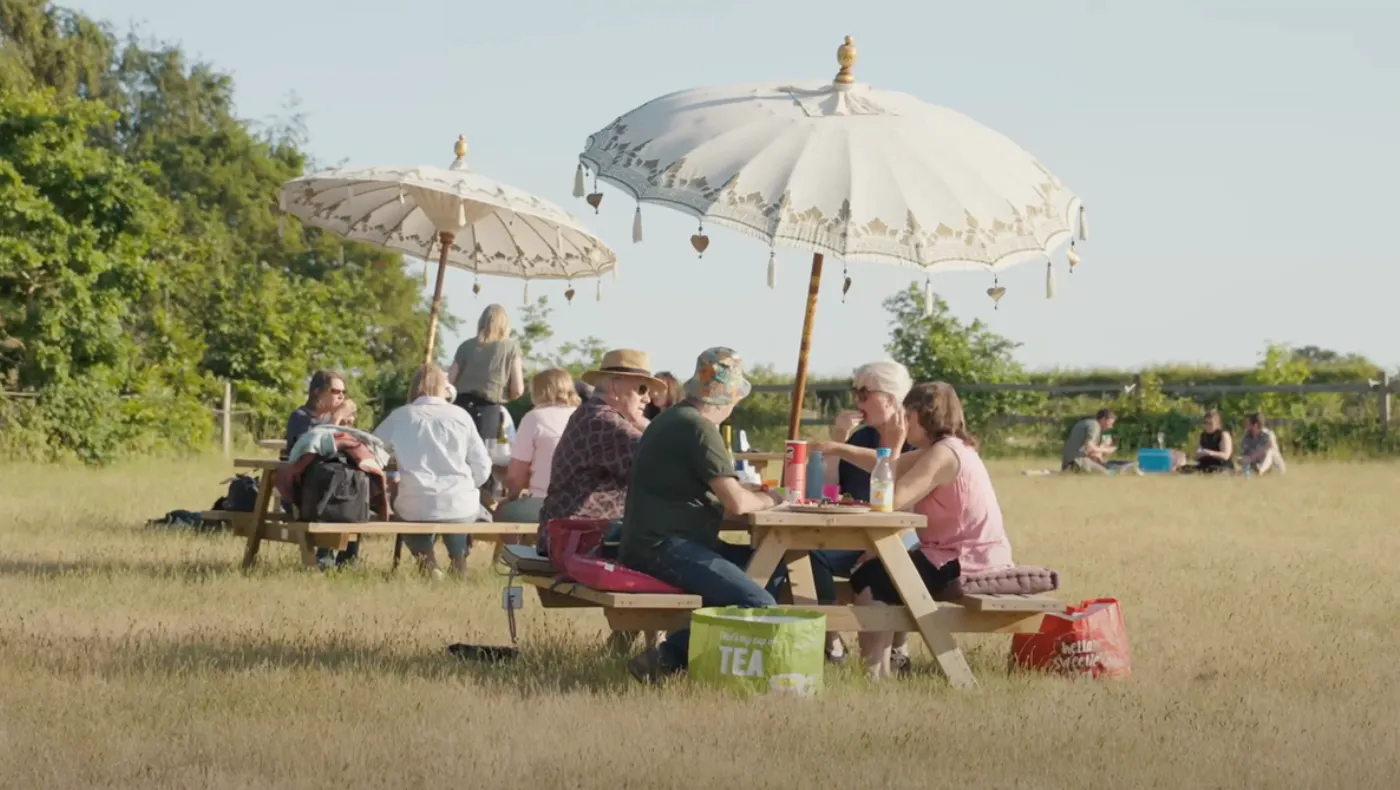 People enjoying a picnic in the sun before the theatre performance