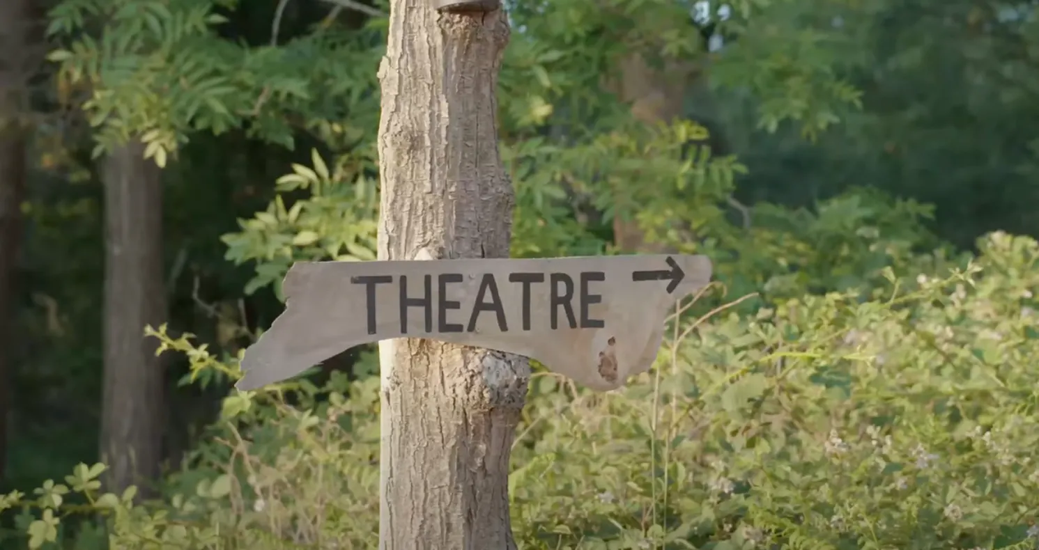 Theatre this way wooden sign