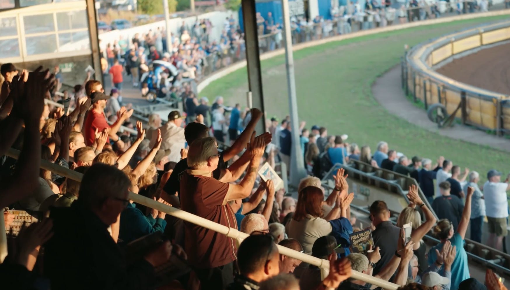 Crowd in the stadium cheering and standing on their feet
