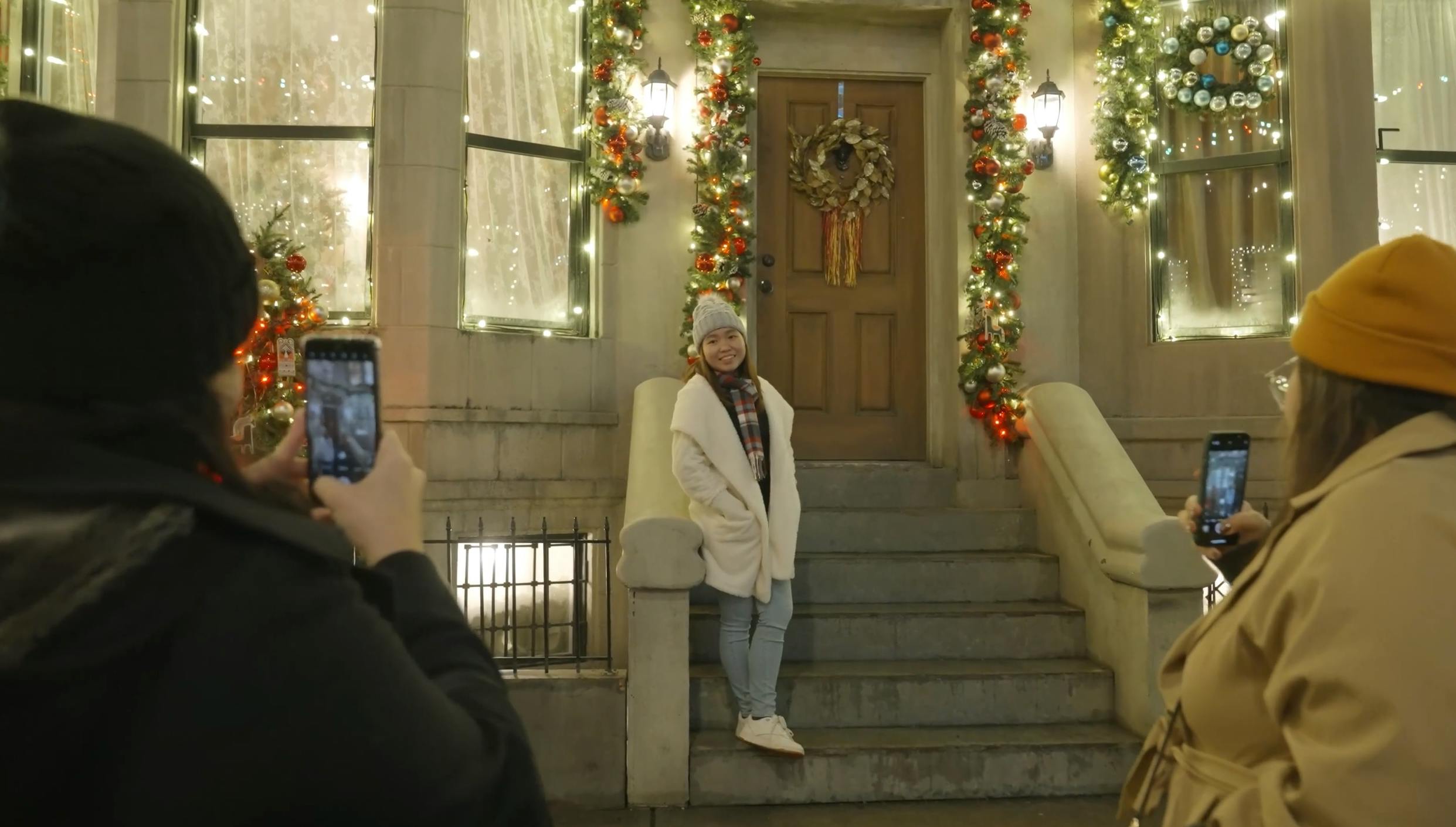 Girl on step at Martini Town having photo taken on mobile phone by her friends