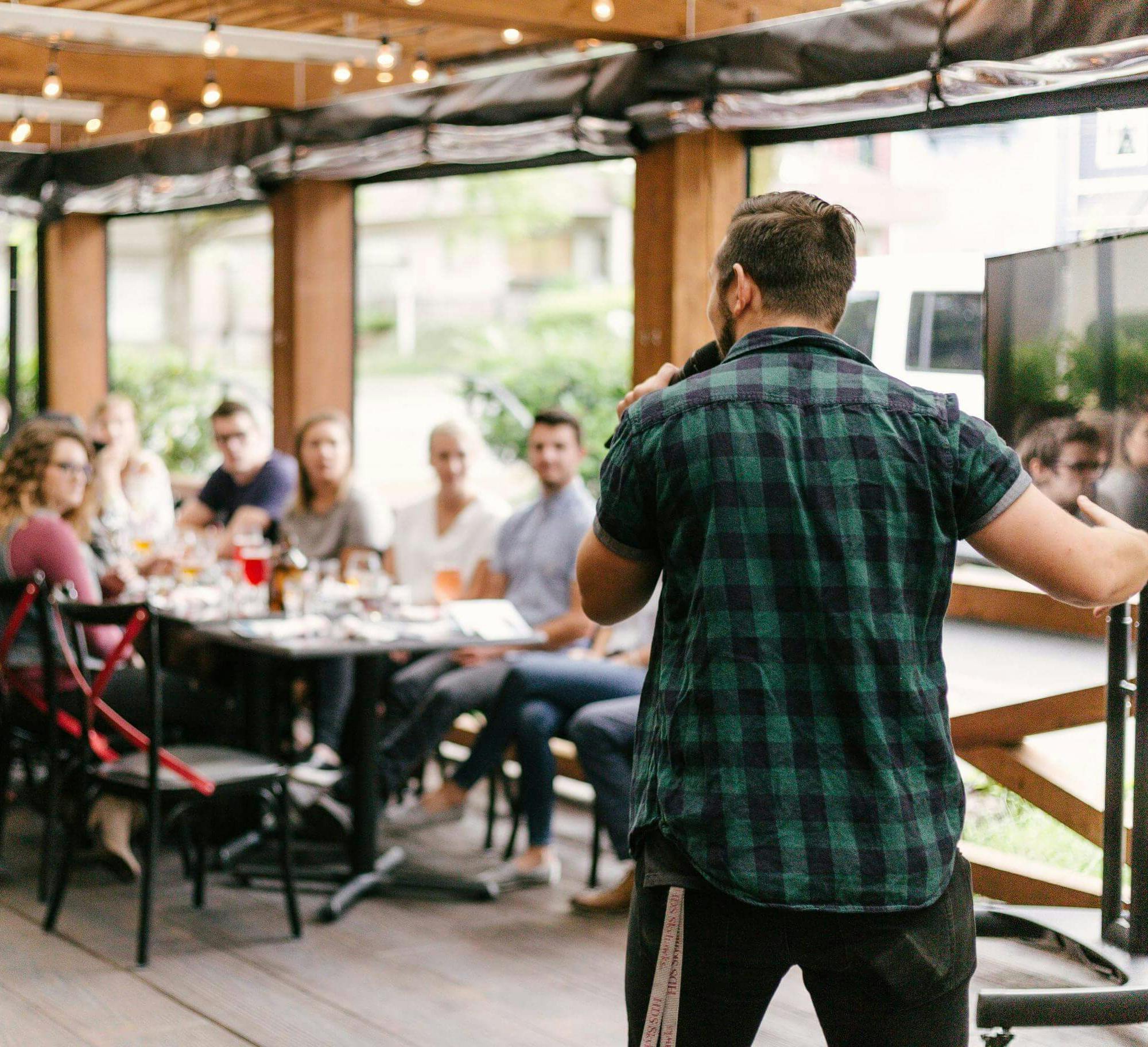 Man speaking to people on mic