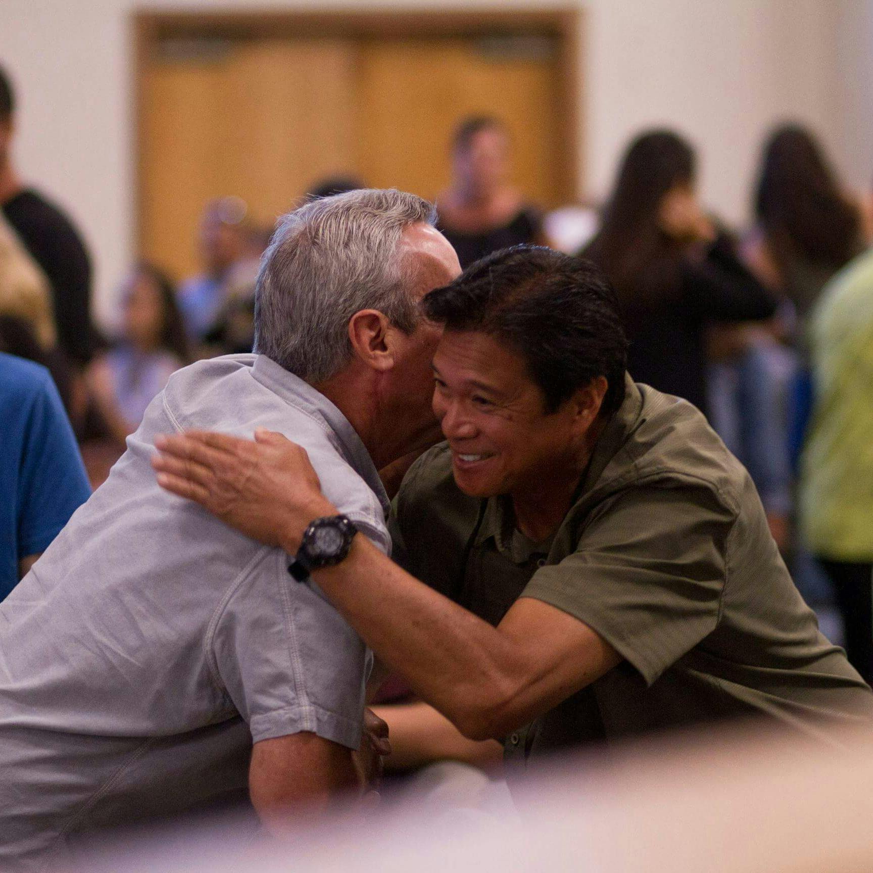 two men hugging at event