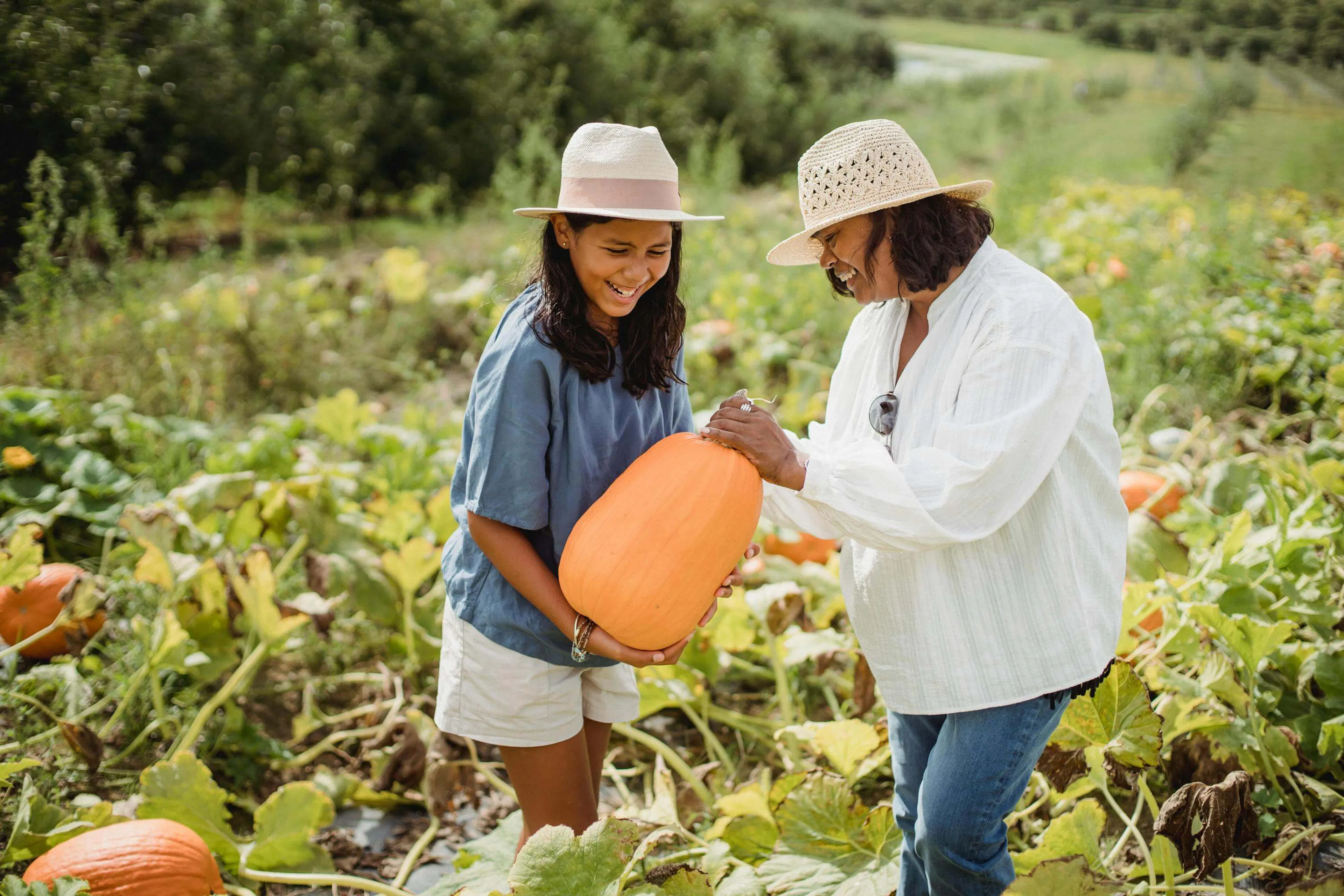 Mother and daughter picking pumpkin