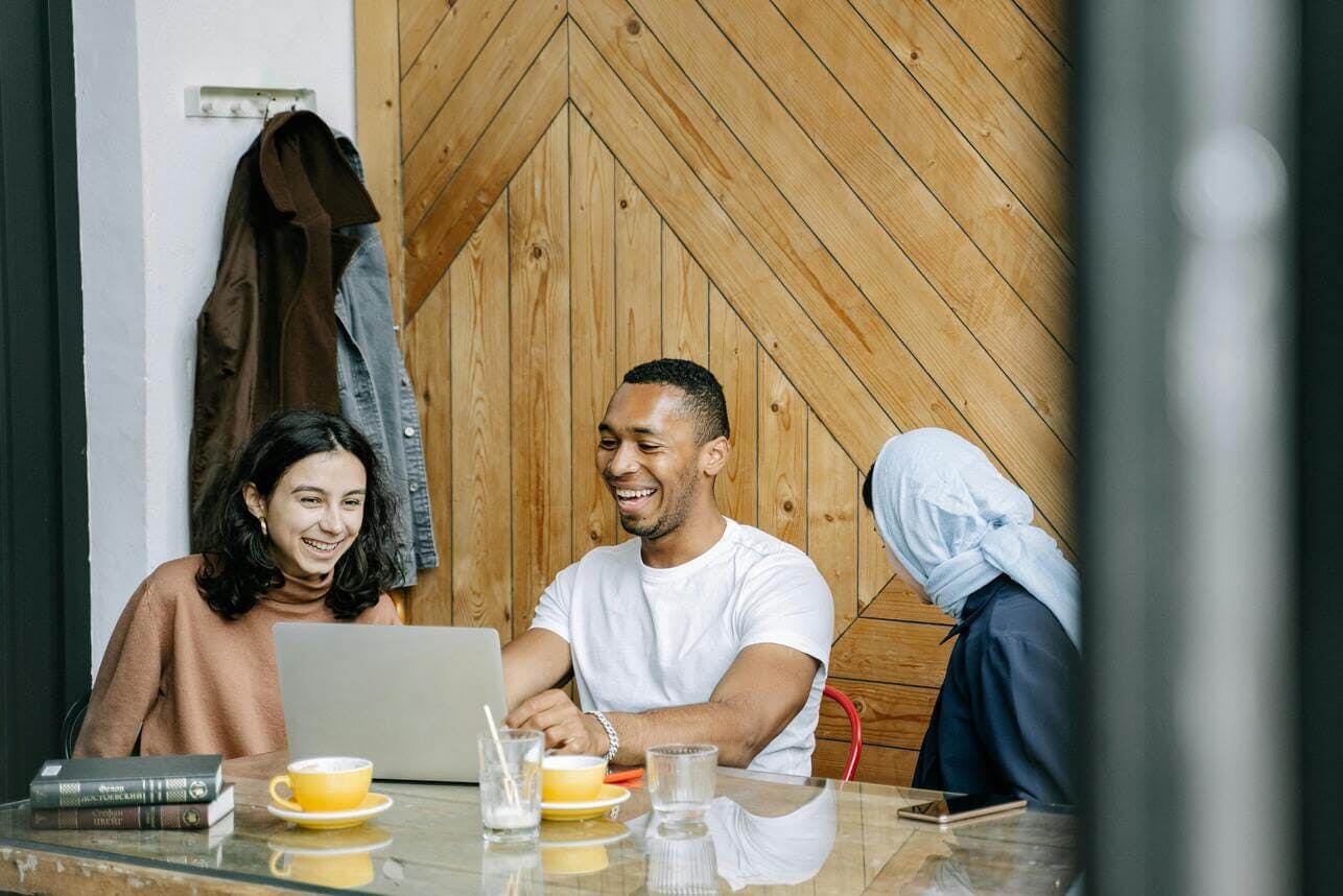people working and laughing around a table