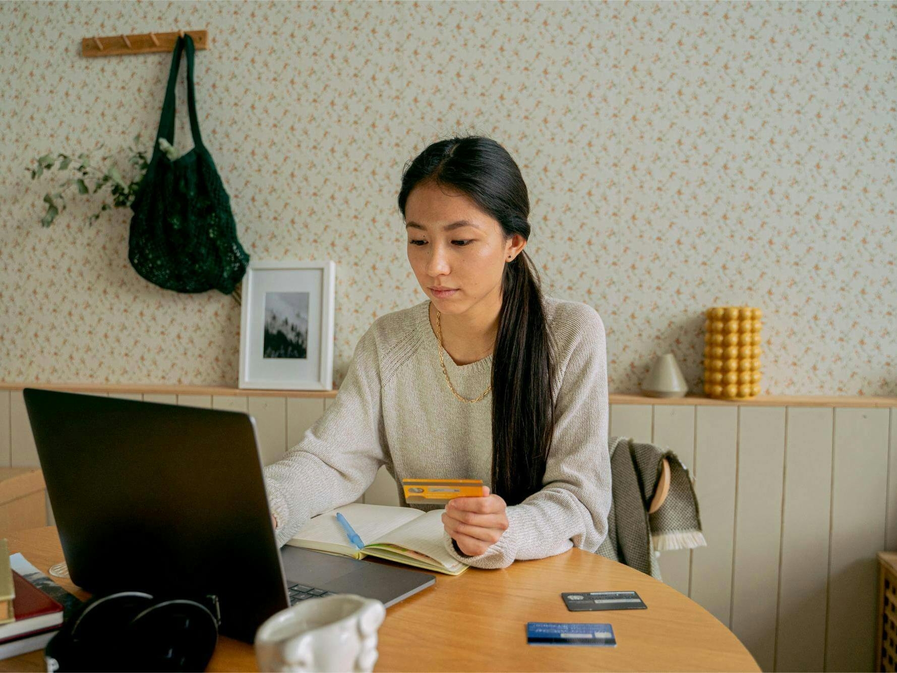 Woman making payment on laptop at table