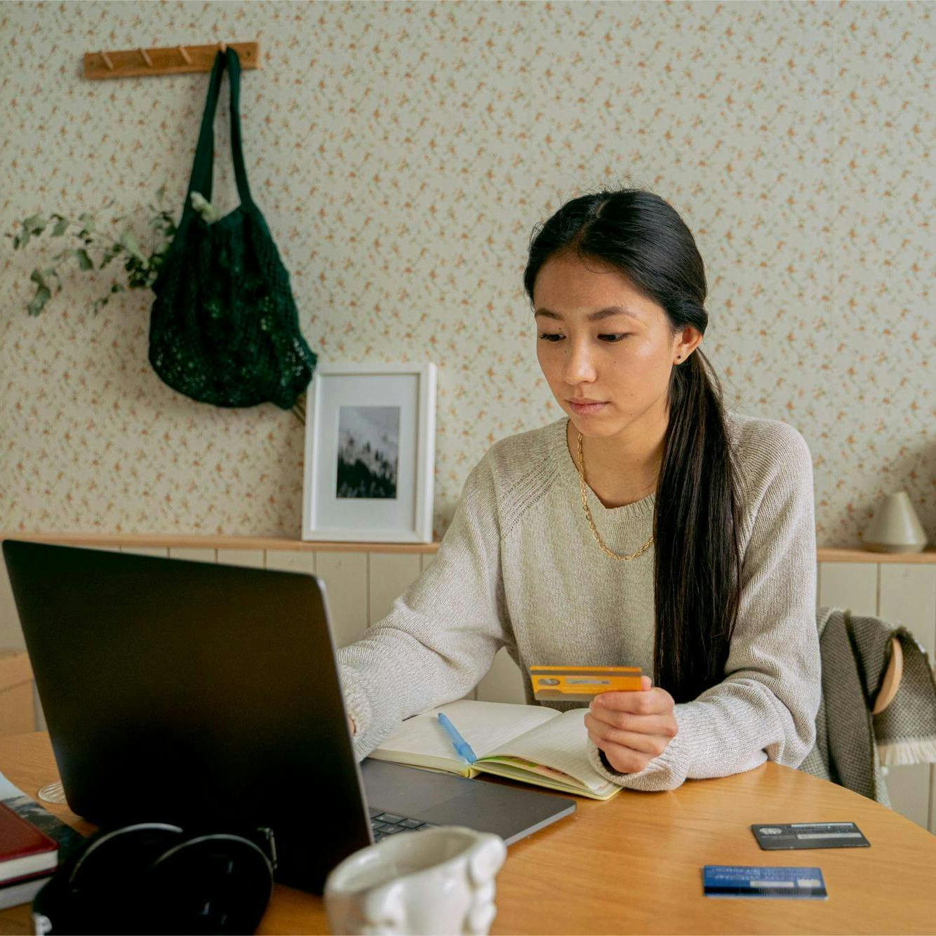 Woman making payment on laptop at table