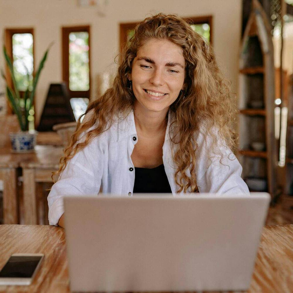 Woman on computer smiling