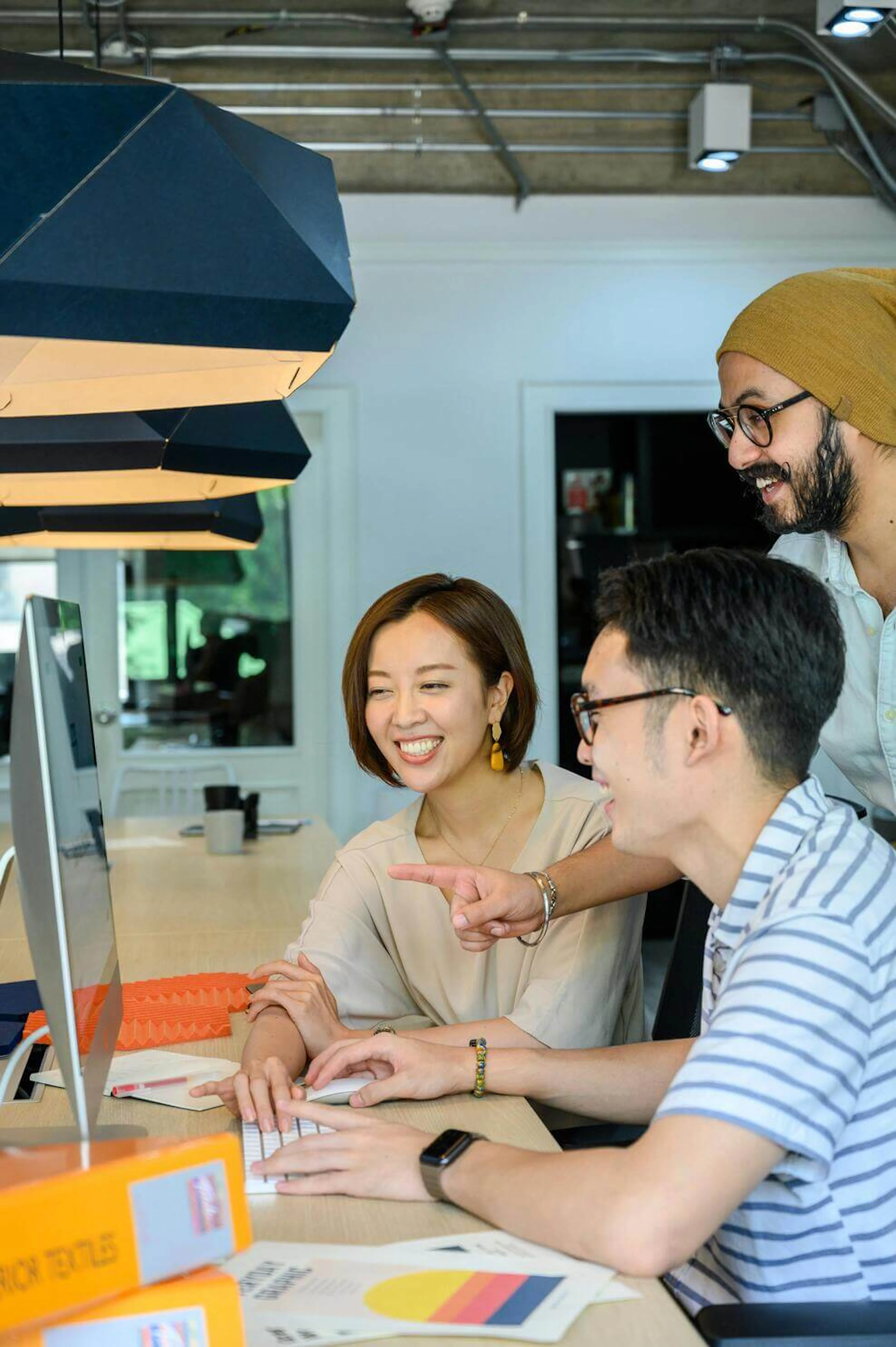 People smiling while looking at computer screen
