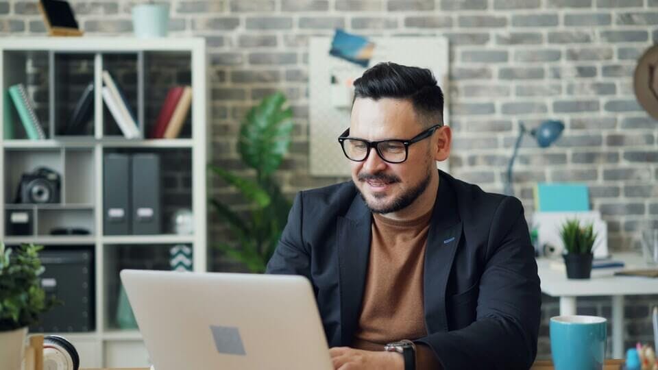 Man on computer smiling