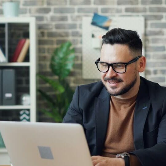 Man on computer smiling