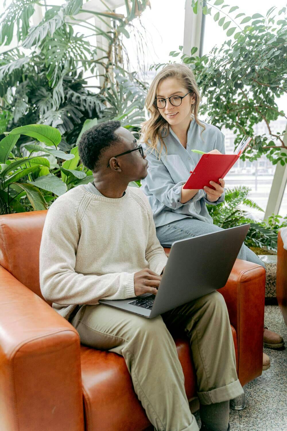 Man and woman working together with laptop