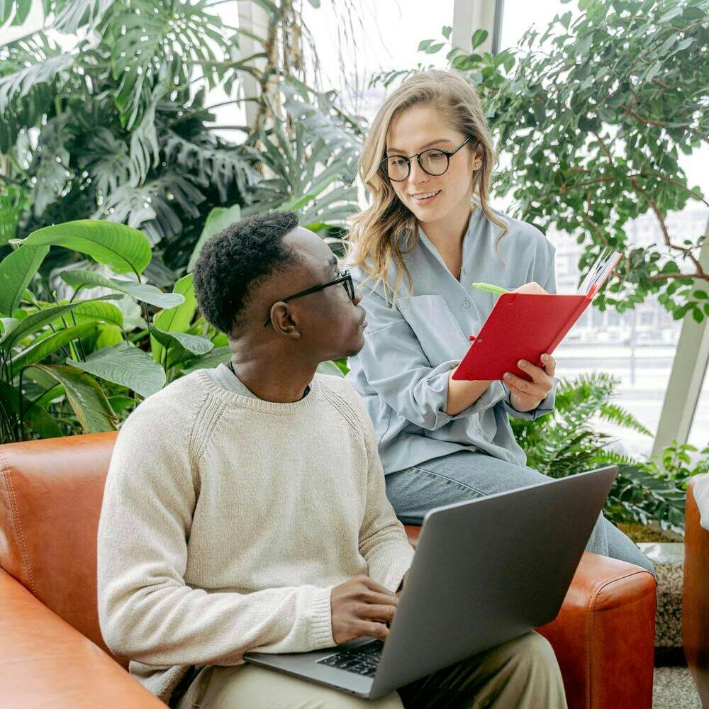 Man and woman working together with laptop