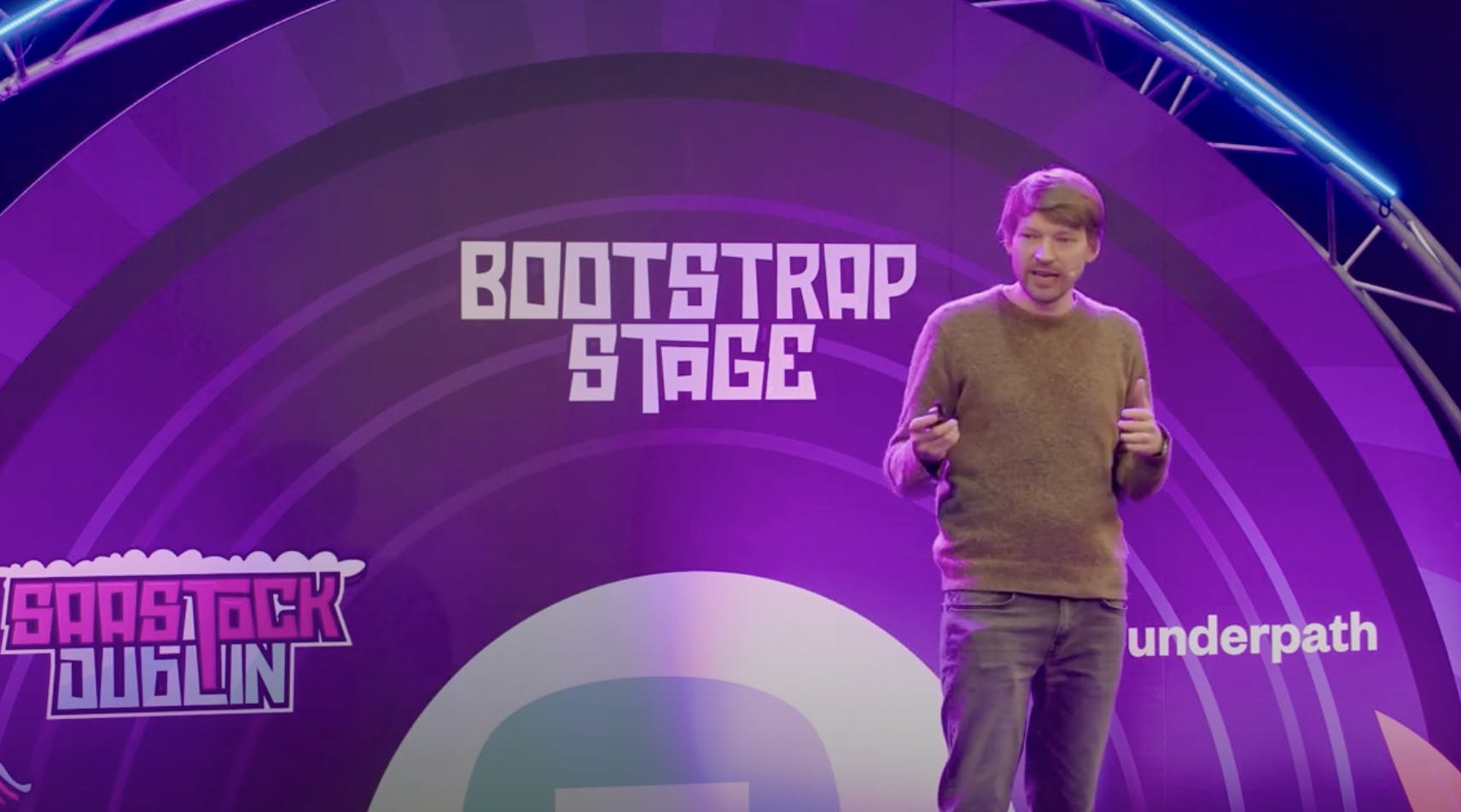 Jonny presenting on the stage at saastock conference