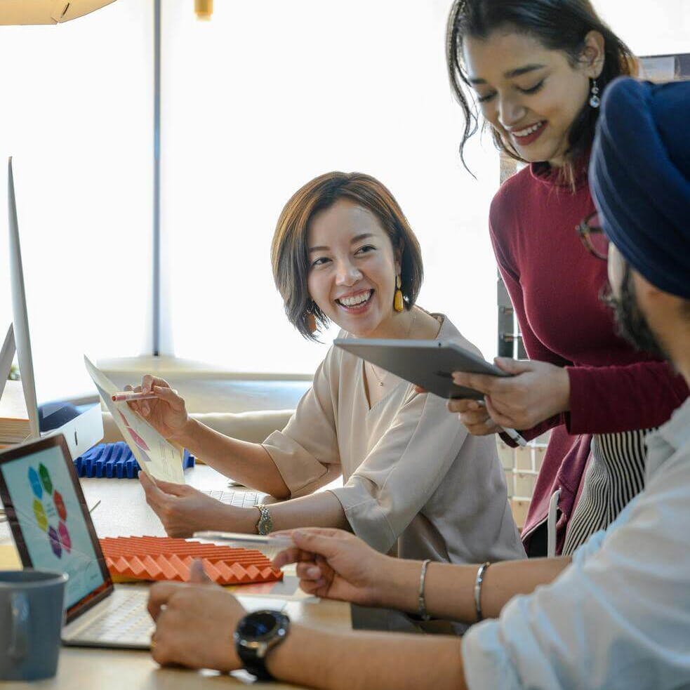 people working together by laptop