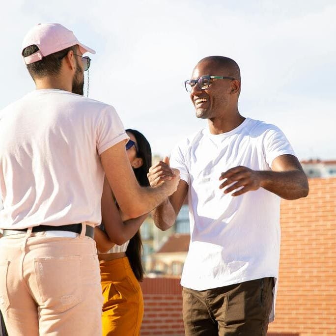 two men greeting each other