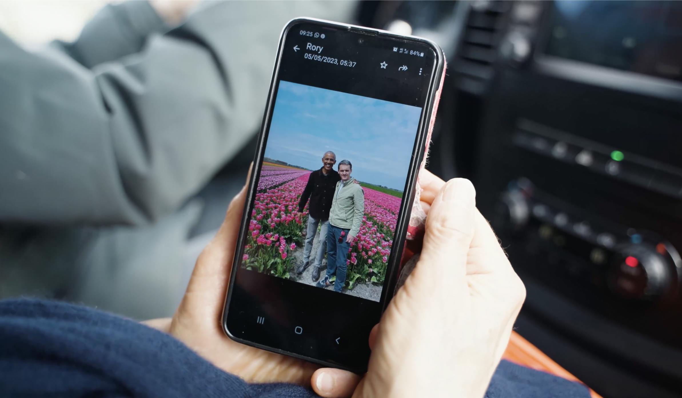 Mobile phone showing a photo of Rory and Barack Obama
