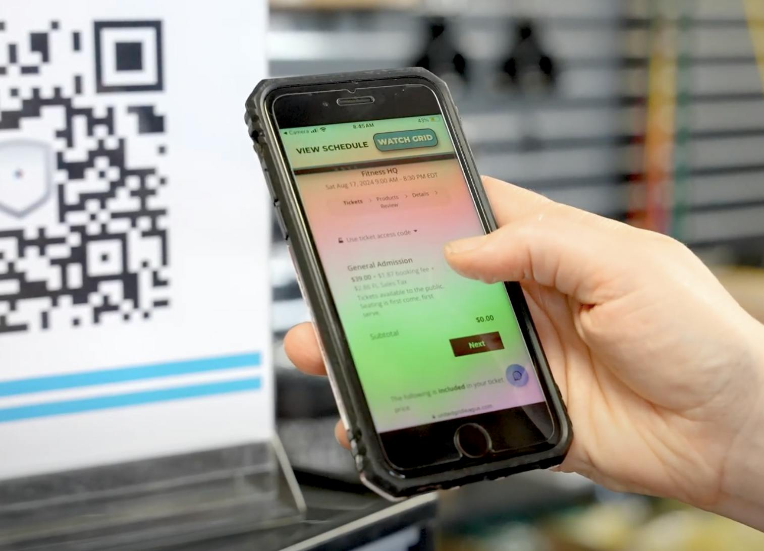 United Grid League Phone scanning the Buy Tickets QR code