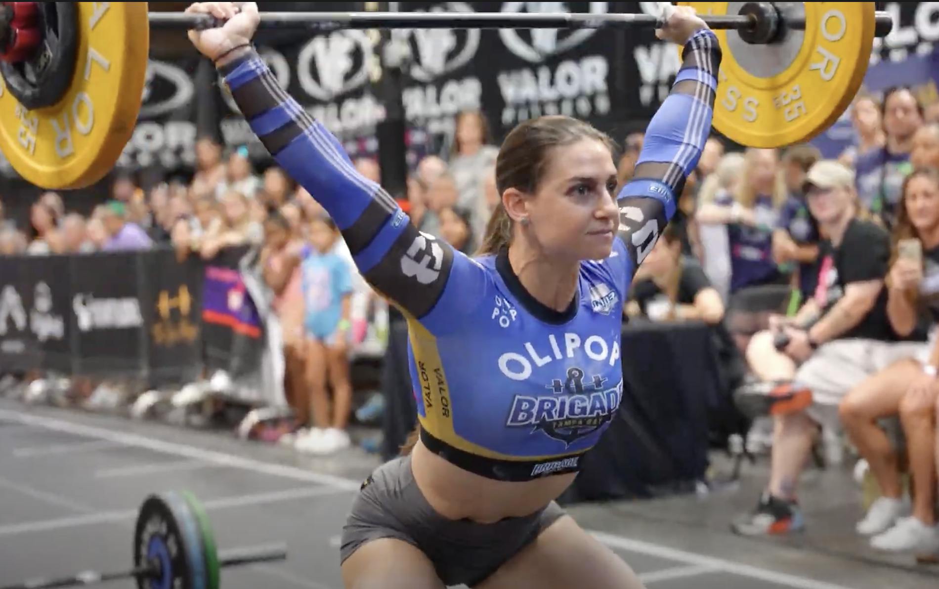 United Grid League Female weightlifter with barbell above head